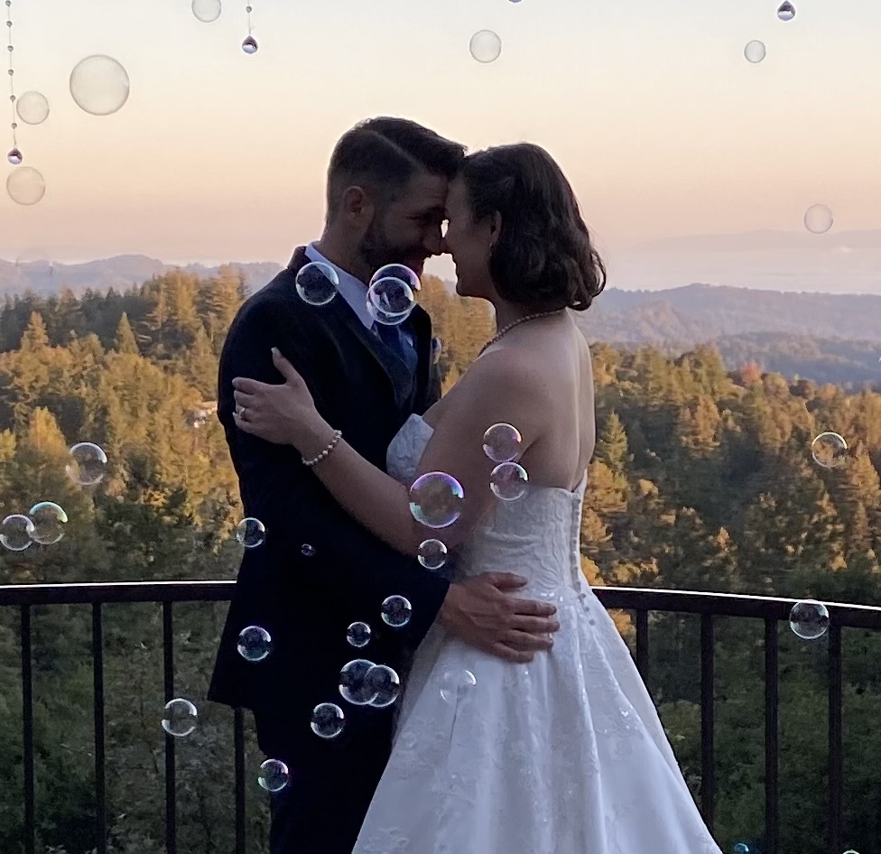Couple at sunset with bubbles and fall foliage at Living Well