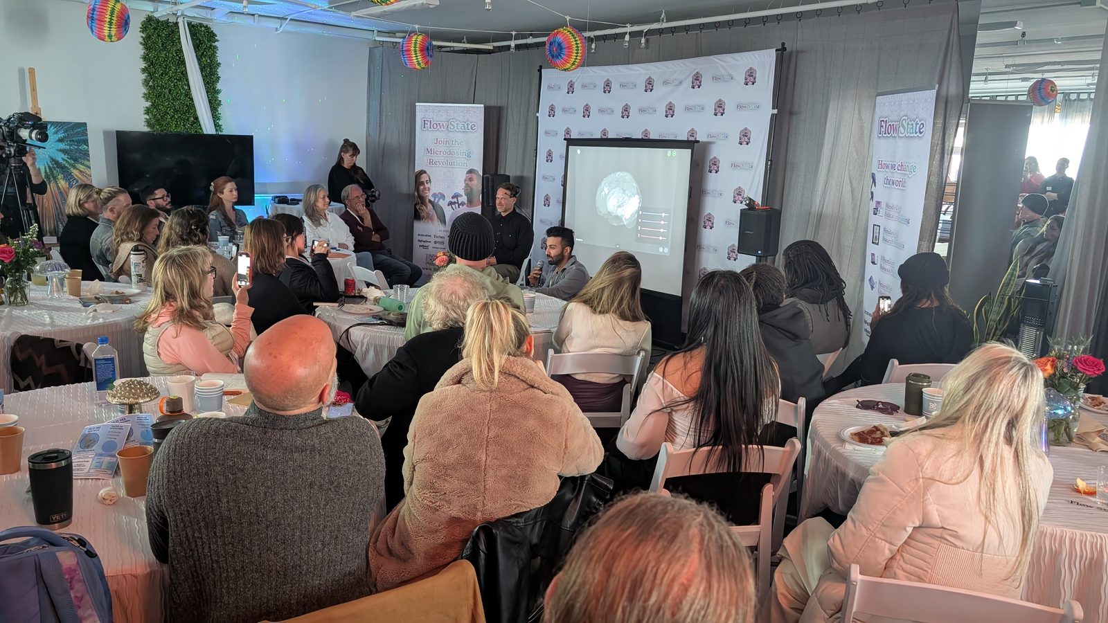 Indoor Flow State seminar with seated guests at Living Well Event Center