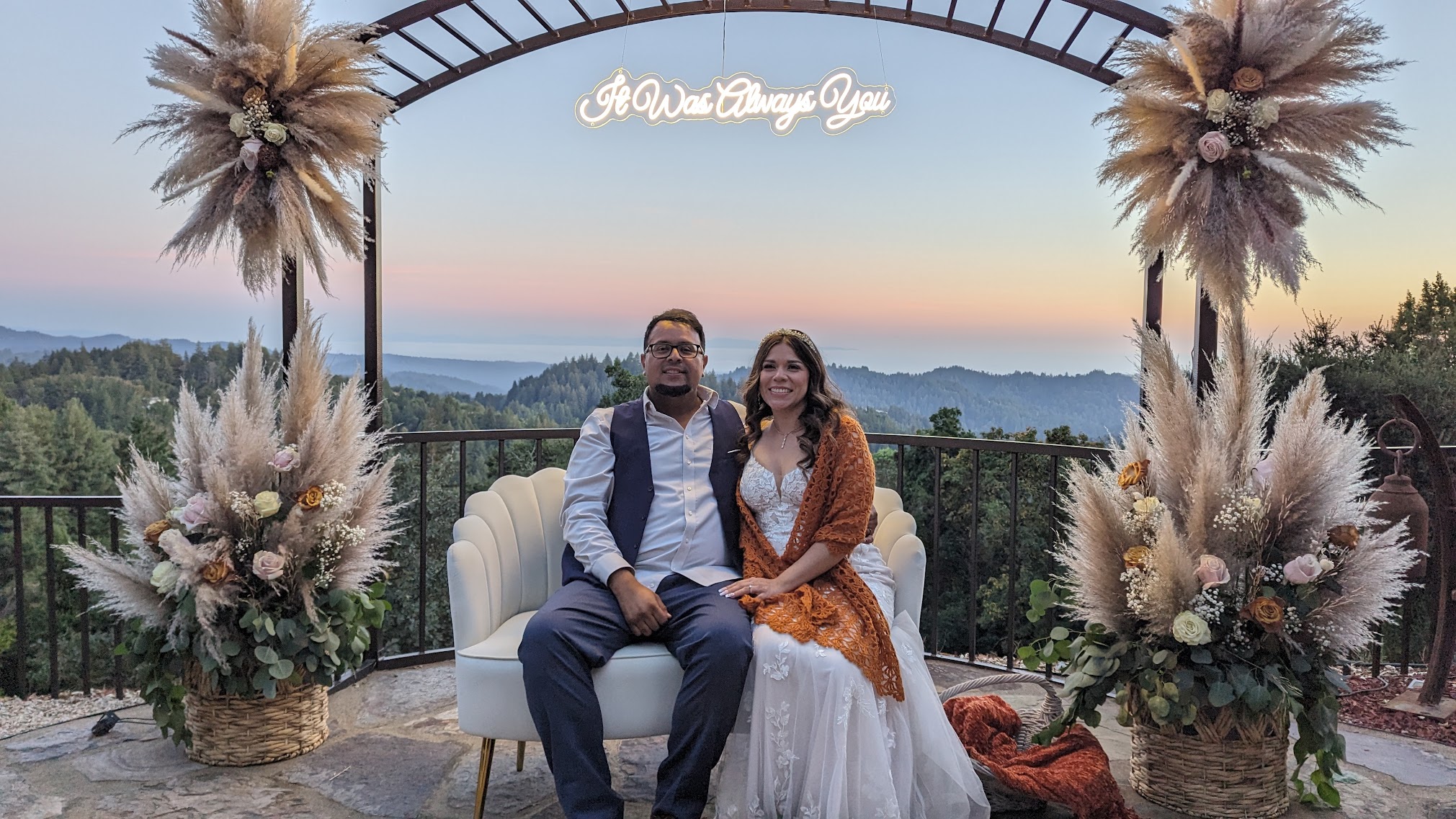 Couple under neon sign at sunset at Living Well