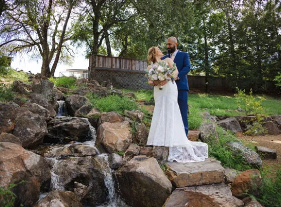 Couple beside the waterfall at Living Well Event Center